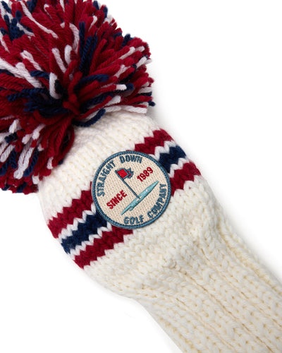 Straight Down Pom Pom Driver Headcover in Red White Blue, close-up view featuring the Straight Down Golf Company Since 1989 embroidered patch and red and navy stripe knit detail