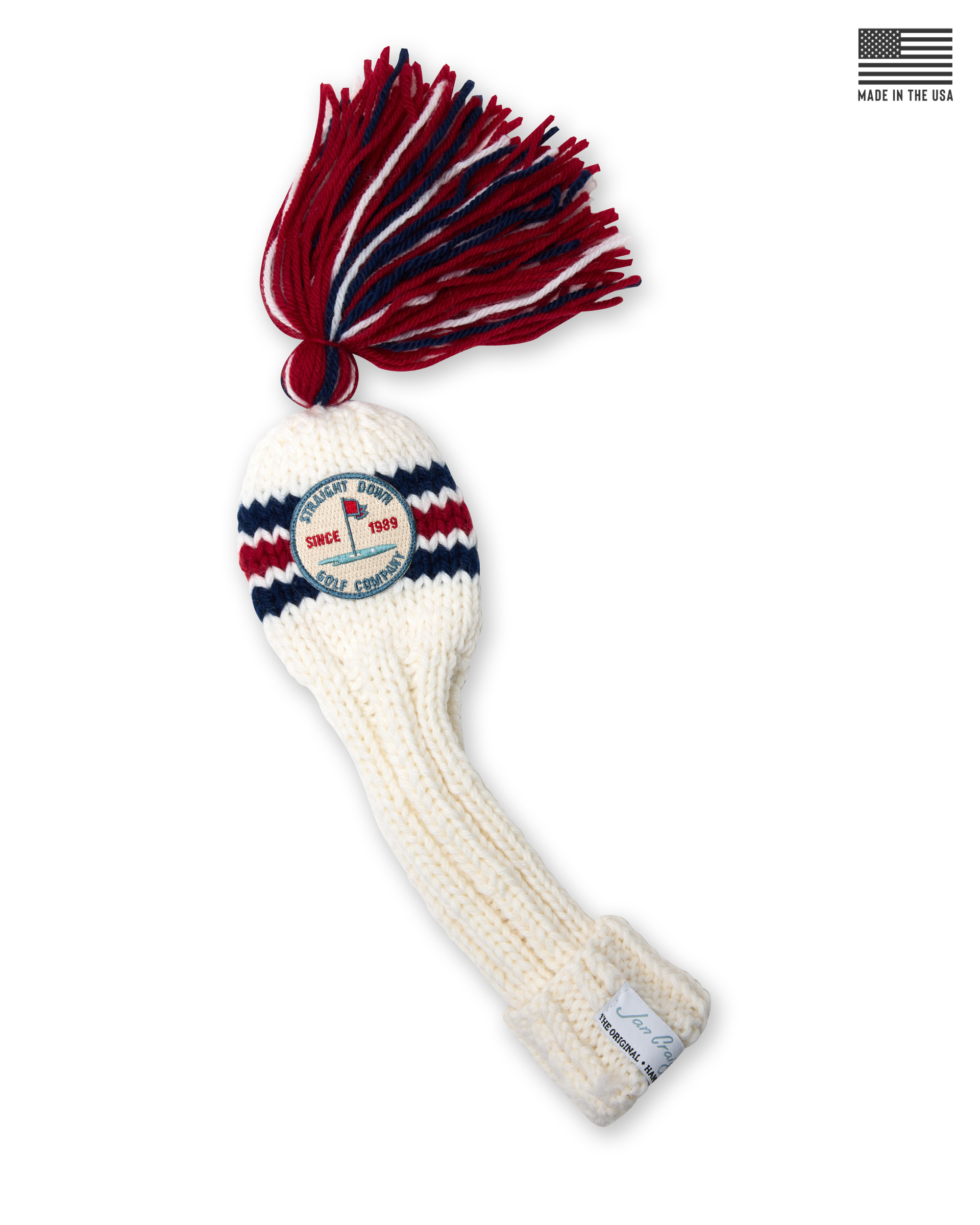 Straight Down Fairway Tassel Headcover in Red White Blue, product view featuring a cream hand-knit cable knit fairway headcover with red and navy stripe detail, a red, white, and navy tassel, and the Straight Down Golf Company Since 1989 patch