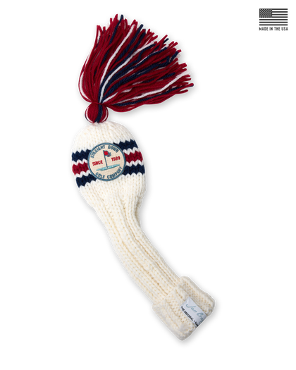 Straight Down Fairway Tassel Headcover in Red White Blue, product view featuring a cream hand-knit cable knit fairway headcover with red and navy stripe detail, a red, white, and navy tassel, and the Straight Down Golf Company Since 1989 patch