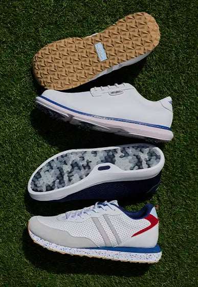 Four golf shoes arranged vertically on green grass, showing the outsole, side profile, and top view of a white sneaker with blue, gray, and red accents.