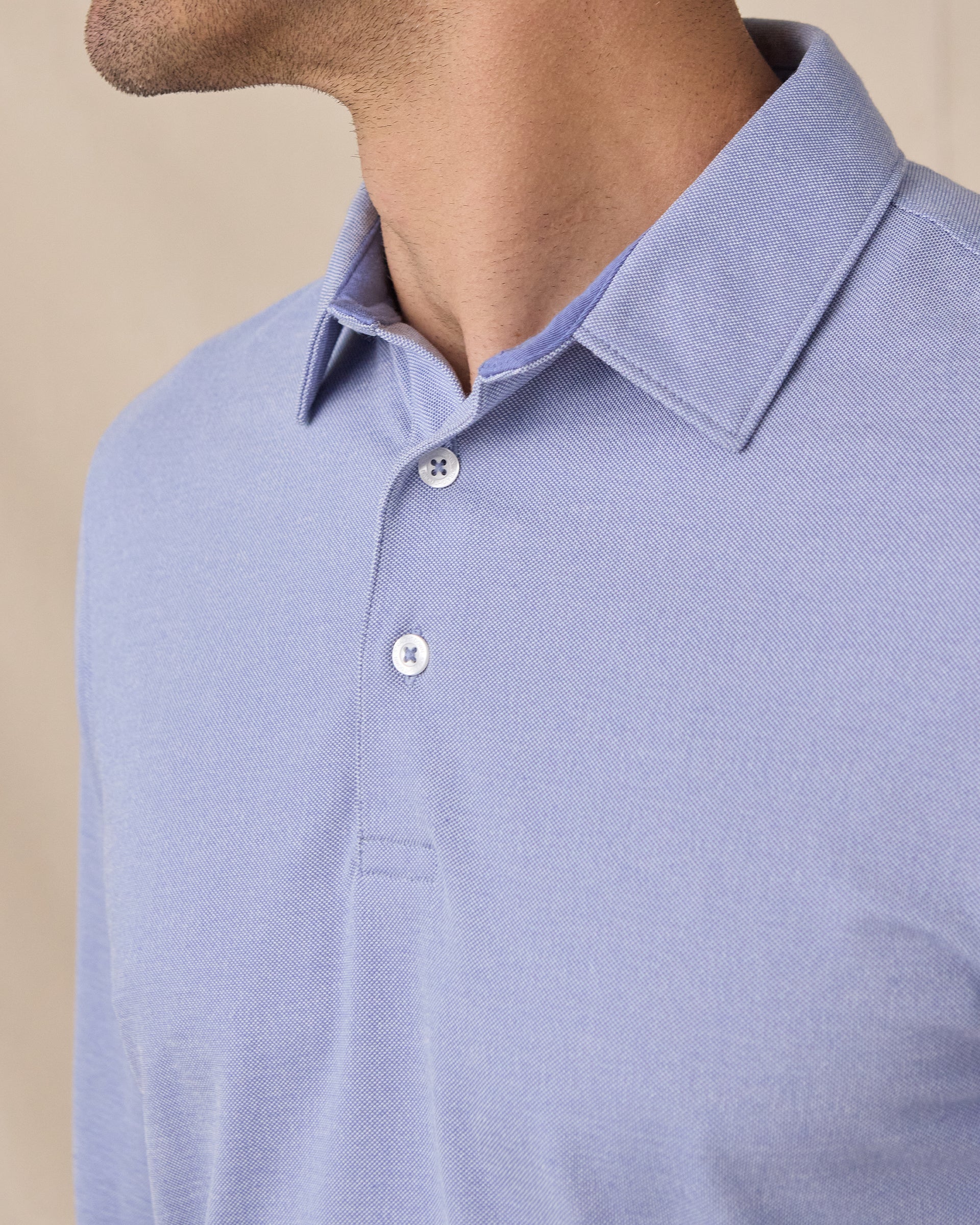 Close-up of the Cambridge Long Sleeve Polo in Chambray Blue highlighting the structured collar and refined knit texture
