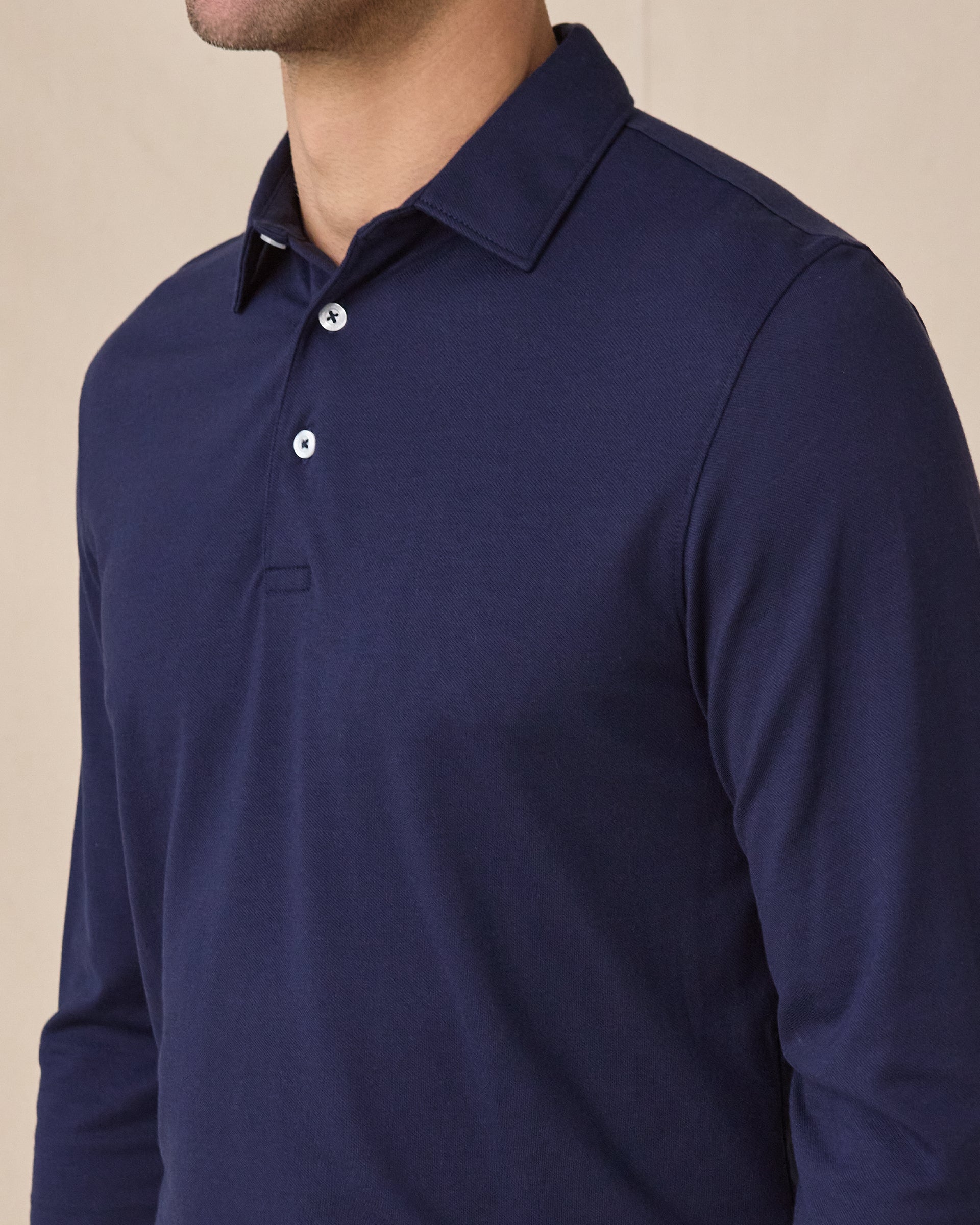 Close-up of the Cambridge Long Sleeve Polo in New Indigo highlighting the structured collar and refined knit texture