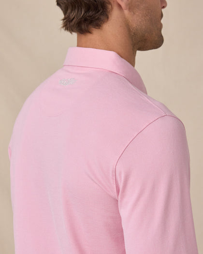 Close-up of the Cambridge Long Sleeve Polo in Punch Pink featuring the embroidered Straight Down logo at the back neck and oxford pique knit texture