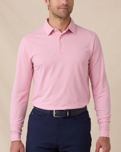 Model wearing the Cambridge Long Sleeve Polo in Punch Pink, front view