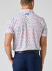Grillin' Polo in White, on model back view showing the all-over scattered Fourth of July themed print in red and blue tones on a white base with Straight Down logo at the upper back, styled with navy pants and a navy belt