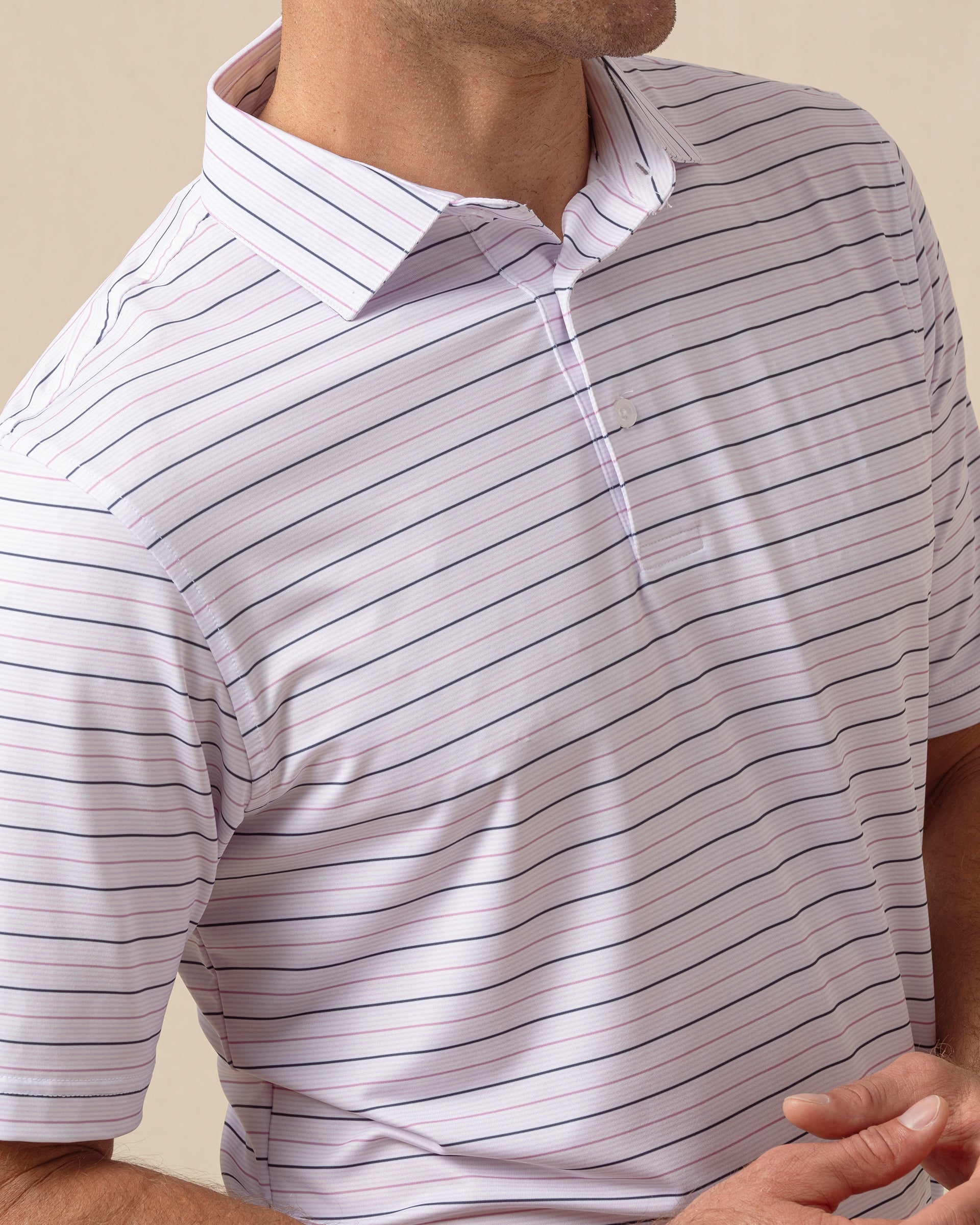 Close-up of men’s lilac striped polo showing fine horizontal stripes and structured collar