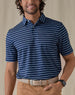 Men's Quintero Stripe Polo in Green Stone, front view on model featuring a navy base with light blue horizontal stripe pattern, paired with tan pants and a tan leather belt
