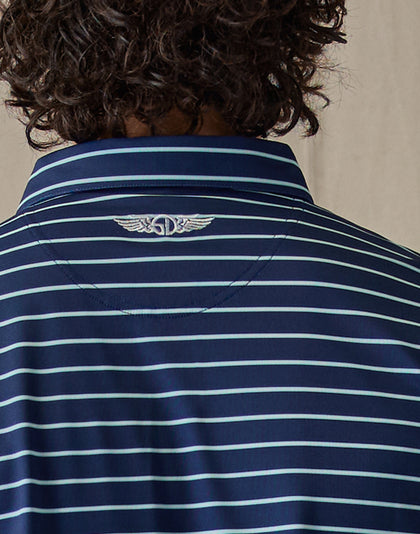 Men's Quintero Stripe Polo in Green Stone, close-up back view highlighting the embroidered Straight Down logo at the upper back on a navy base with light blue horizontal stripe pattern