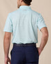 Back view of a man wearing the mint striped Quintero Polo with navy pants.