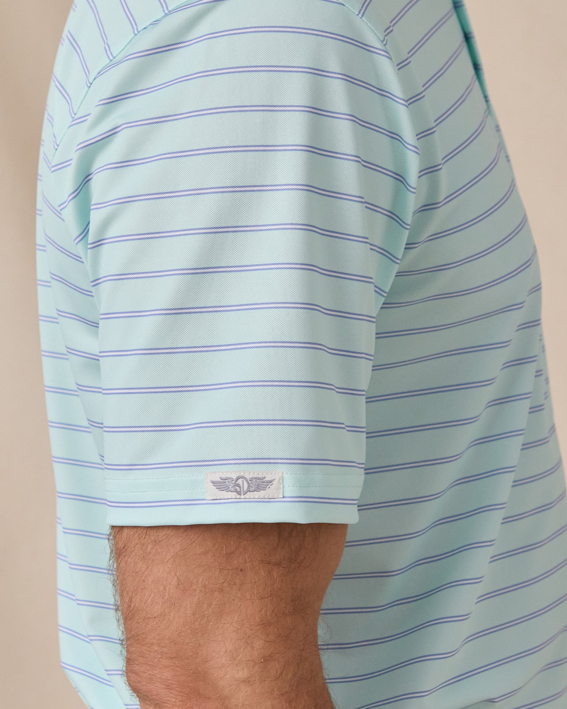 Close-up of the striped short sleeve with a Straight Down logo tab at the hem.