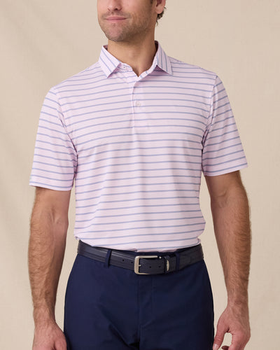 Model wearing the Quintero Stripe Polo in Lilac, a striped performance golf polo