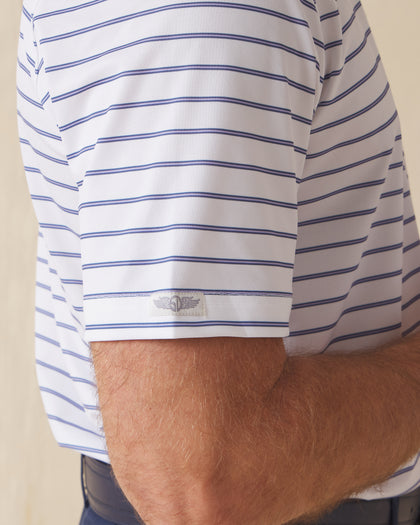 Men's Quintero Stripe Polo in Violet, close-up model view featuring the sleeve hem with the Straight Down logo tab detail on a white short sleeve polo with horizontal blue and navy pencil stripes