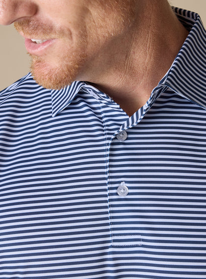 Close-up collar and button placket detail of Del Mar Stripe Polo in New Indigo