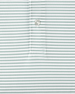 Close-up of light green and white striped performance polo fabric and placket