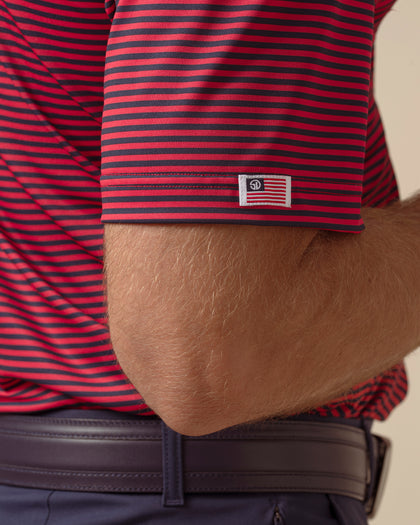 Del Mar Stripe Polo in New Indigo / Flag Red, sleeve logo detail view