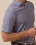 Close-up of indigo and lilac striped polo sleeve with embroidered logo detail