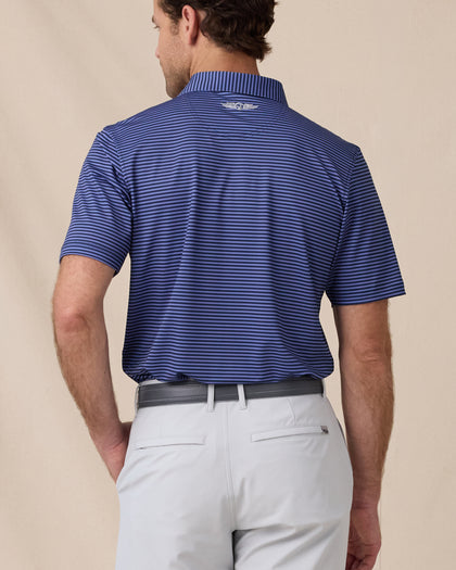 Back view of men’s striped tidal blue polo with collar logo detail, tucked into silver shorts