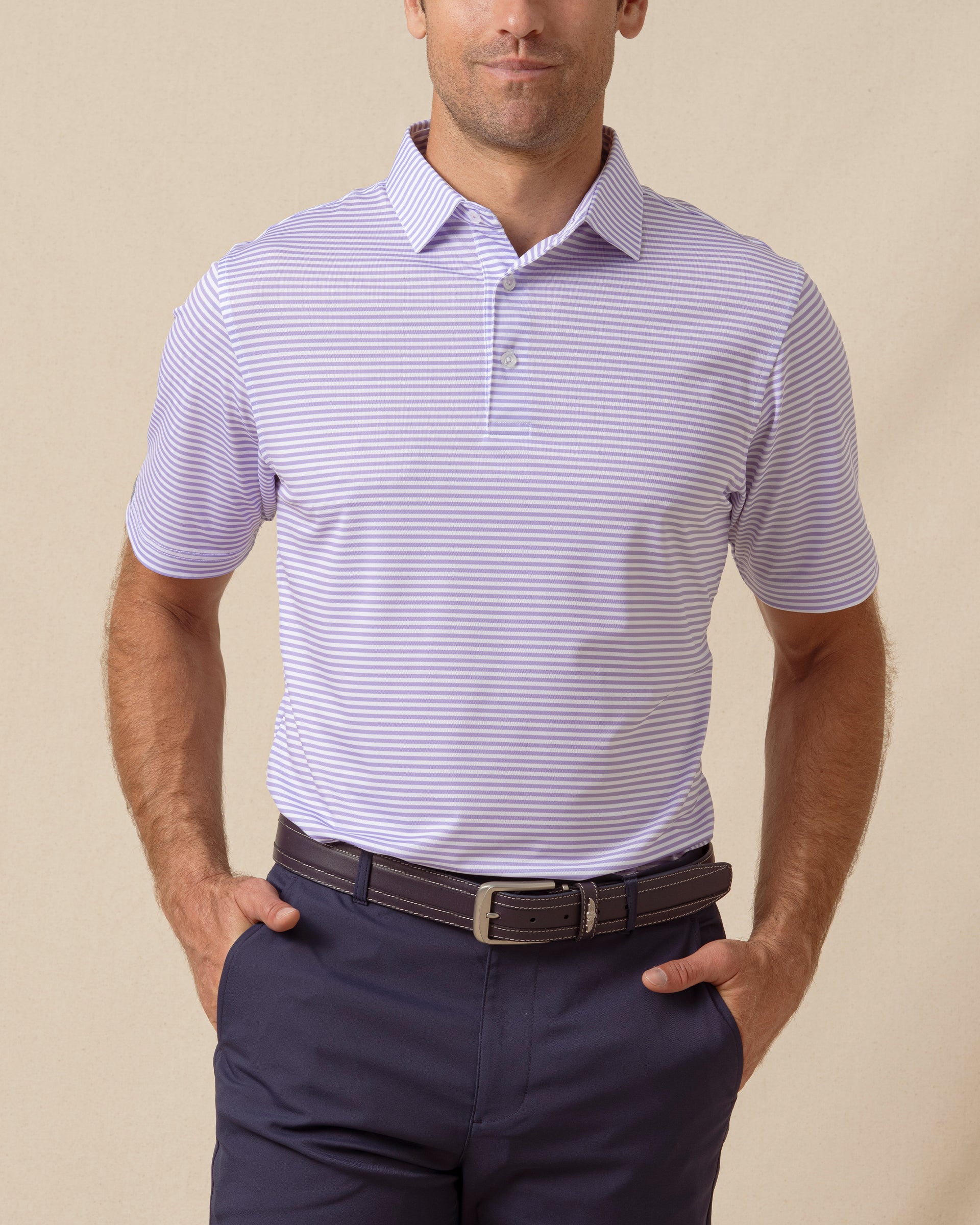 Men’s striped violet polo with short sleeves and button placket, paired with navy shorts