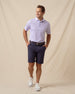 Men’s striped violet polo styled with navy shorts, brown belt, and white sneakers
