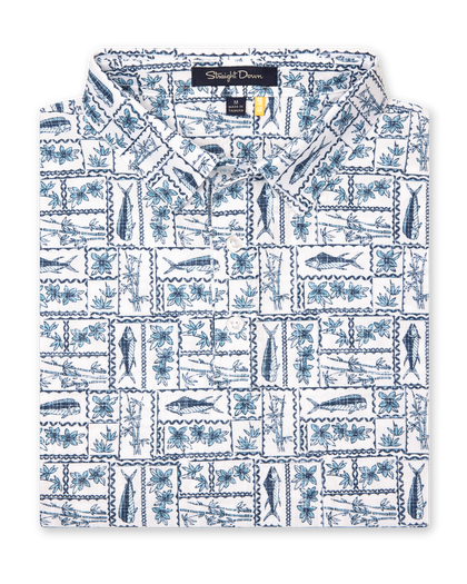 Men's Dorado Polo in Coastal, folded flat lay front view featuring an allover tiled print with fish, tropical flowers, and bamboo motifs in navy and light blue on a white base