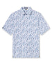 Men's Dorado Polo in Coastal, flat lay front view featuring a white base with a navy and blue tiled fish, floral, and bamboo stamp print, with Straight Down logo patch visible on sleeve