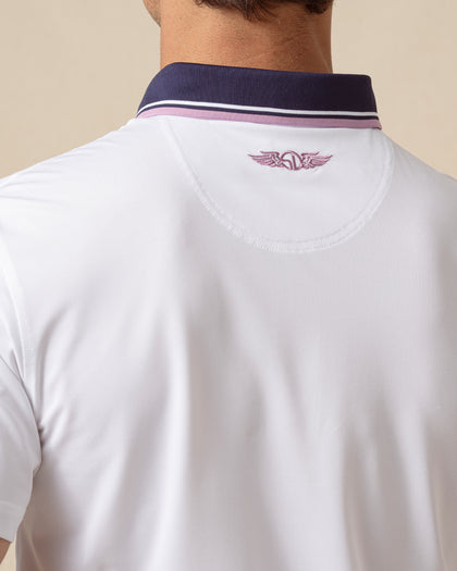 Back collar detail of white polo with embroidered logo and contrast striped trim