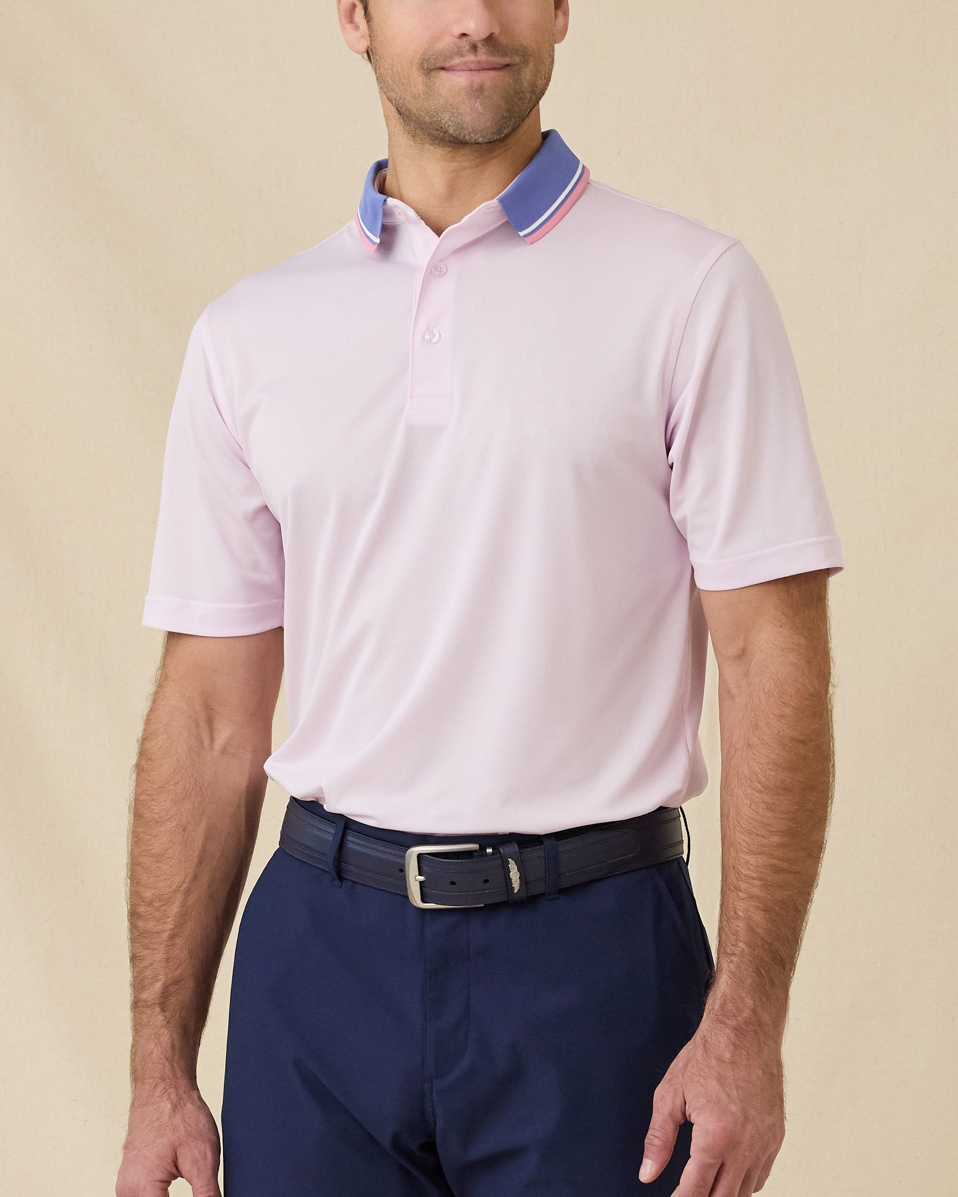 Model wearing the Chorro Polo in Lilac, a performance golf polo with a contrast collar