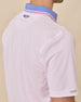 Sleeve and collar detail of the Chorro Polo in Lilac showing the contrast blue collar with pink and white tipping and signature logo embroidery