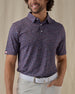Men's American Muscle Polo in New Indigo, front view on model featuring a navy, burgundy, and sky blue classic car novelty print, paired with light gray pants and a white belt, with an American flag woven label at the sleeve