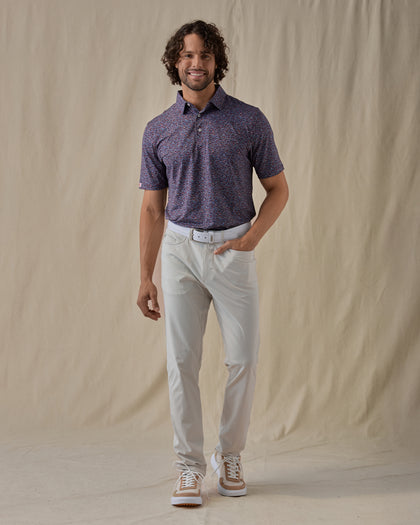 Men's American Muscle Polo in New Indigo, full-length front view on model featuring a navy, burgundy, and sky blue classic car novelty print, paired with light gray pants and tan shoes