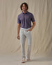 Men's American Muscle Polo in New Indigo, full-length front view on model featuring a navy, burgundy, and sky blue classic car novelty print, paired with light gray pants and tan shoes