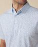 Men's American Muscle Polo in Moonlight, close-up on-model detail view featuring a navy classic car sketch novelty print with a spread collar and button placket