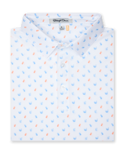 Men's Tropical Daze Polo in Carolina, folded flat lay front view featuring a scattered pineapple and coconut drink novelty print in sky blue and peach on a white ground with a button placket and spread collar