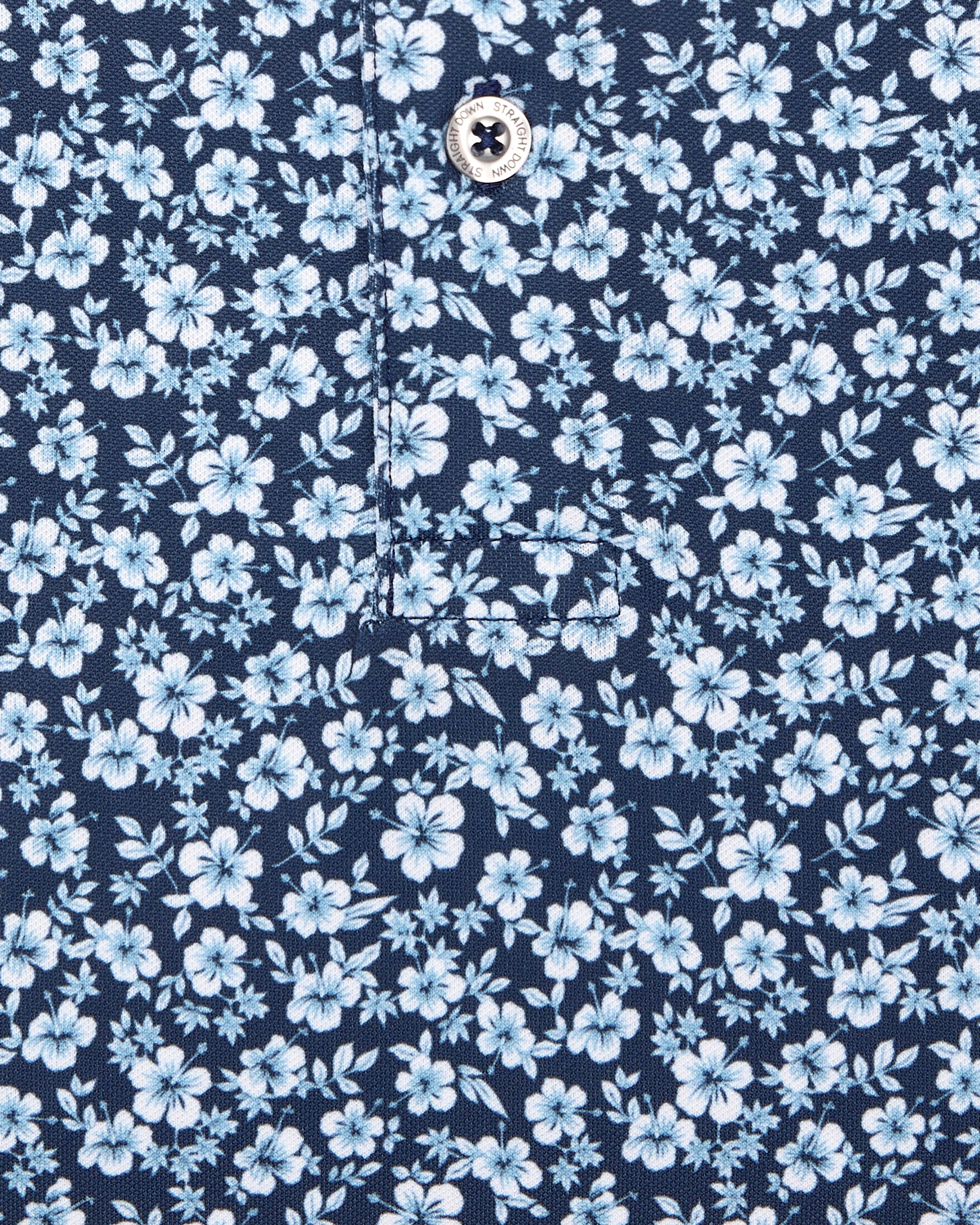 Men's Don Ho Polo in New Indigo, close-up flat lay fabric detail view highlighting the all-over light blue floral print on a navy base
