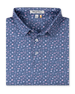 Men's Hold Em Polo in Moonlight, folded flat lay front view featuring an allover casino-themed print with playing cards, card suits, poker chips, dice, and cocktail glasses in pink and lavender on a slate blue base