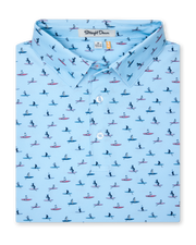 Men's Dog Paddle Polo in Cool Blue, folded flat lay front view featuring an all-over print of dogs paddle boarding on red and blue boards on a light blue body with a two-button placket and Straight Down label