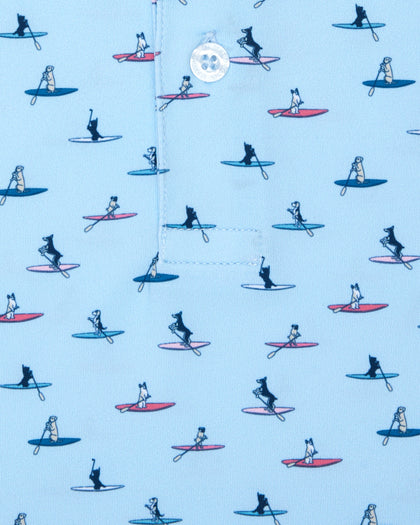 Men's Dog Paddle Polo in Cool Blue, close-up front view featuring various dog breeds paddle boarding on red and blue boards on a light blue body with a Straight Down logo button detail on the placket
