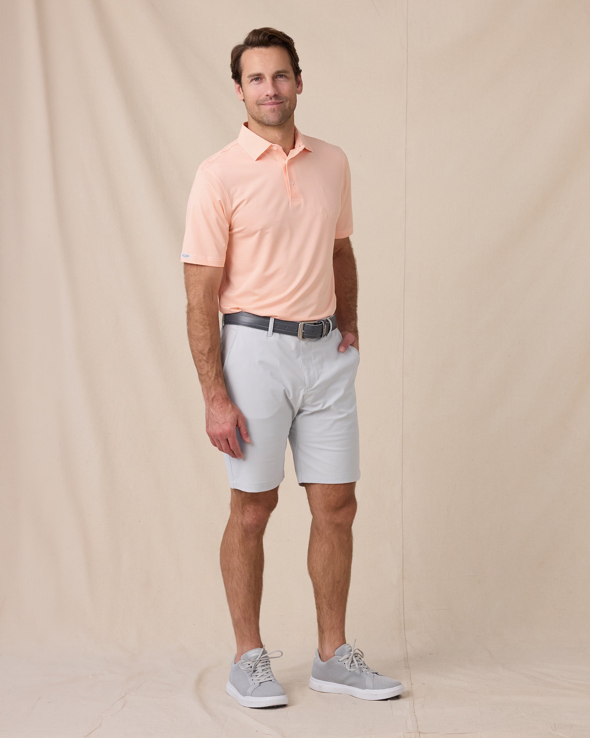 Peninsula Stripe Polo in Cantalope, full outfit model view styled with silver shorts