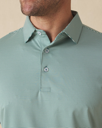 Men's Peninsula Stripe Polo in Celery, close-up detail view on model featuring a green and white micro stripe pattern and Straight Down logo engraved buttons