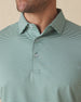 Men's Peninsula Stripe Polo in Celery, close-up detail view on model featuring a green and white micro stripe pattern and Straight Down logo engraved buttons