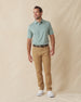 Men's Peninsula Stripe Polo in Celery, full-length front view on model featuring a green and white micro stripe pattern, paired with khaki pants and white golf shoes