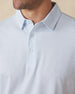 Men's Wilshire Polo in Gemstone, close-up front view on model highlighting the all-over blue geometric micro print on a white base