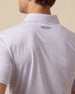 Back collar detail of men’s haze polo with two-tone geometric print and embroidered logo