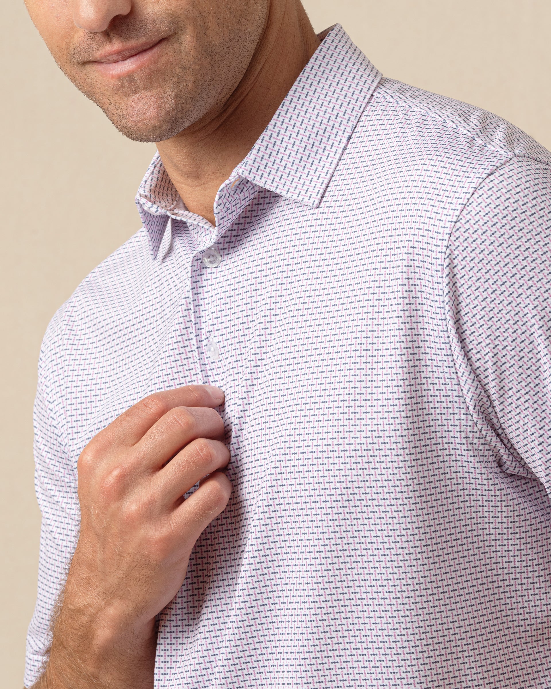 Close-up of men’s haze polo showcasing two-tone geometric print and button placket detail
