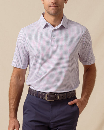 Men’s haze polo featuring a two-tone geometric print, worn with navy shorts