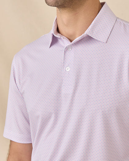 Collar and placket detail of the Wilshire Polo in Punch showcasing the geometric print, self collar, and three-button placket