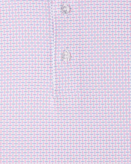Close-up of the Wilshire Polo in Punch highlighting the pink and blue geometric pattern and performance jersey fabric