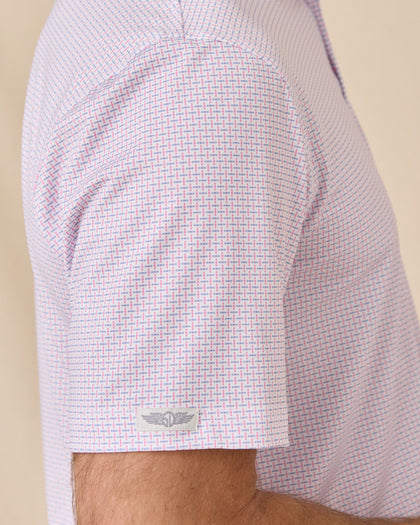 Sleeve detail of the Wilshire Polo in Punch showing the geometric print and Straight Down logo tab