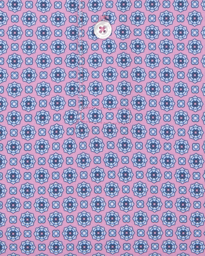 Close-up of pink golf polo with blue geometric print and button detail