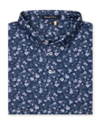 Men's Dogwood Polo in New Indigo, folded flat lay front view featuring an allover floral dogwood blossom print in lavender and white on a navy base